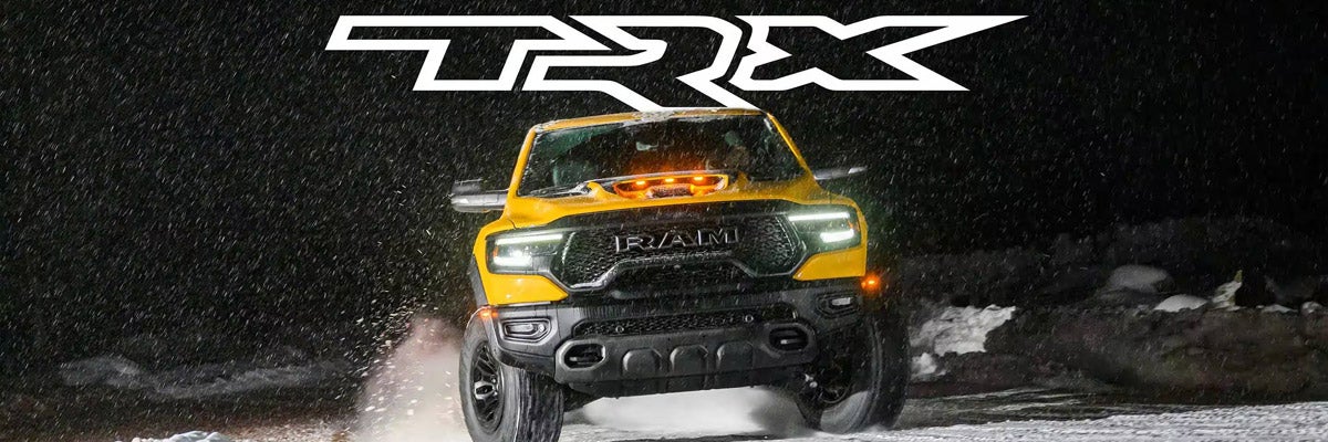 A head-on angle of a yellow 2023 Ram 1500 TRX Havoc Edition